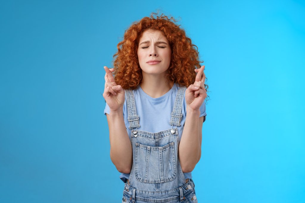 woman trying to calm down while crossing her fingers